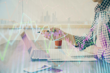 Multi exposure of stock market chart with man working on computer on background. Concept of financial analysis.