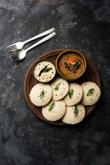 Idli Sambhar or Idly Sambar is a popular south Indian food, served with coconut chutney. selective focus