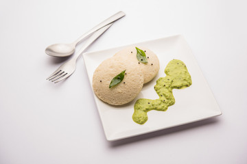 Idli Sambhar or Idly Sambar is a popular south Indian food, served with coconut chutney. selective focus