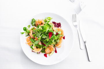 Healthy Salad. Recipe for fresh seafood. Grilled shrimps, prawns, fresh salad lettuce and avocado slices. Healthy Eating. White background. Horizontal photo.