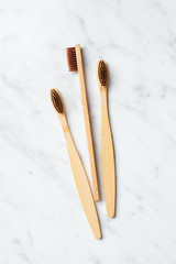 Close up of three bamboo toothbrushes, top view
