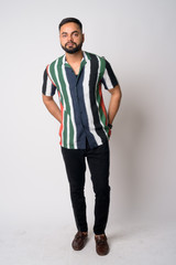 Full body shot of young bearded Indian man