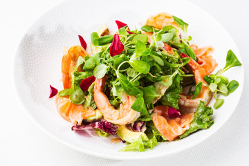 Healthy Salad. Recipe for fresh seafood. Grilled shrimps, prawns, fresh salad lettuce and avocado slices. Healthy Eating. White background. Horizontal photo.