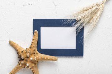 Flat lay frame and starfish on table