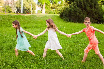 Group of children play on the green grass
