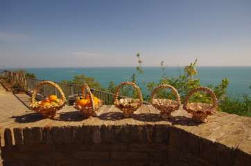 Handmade baskets made with shells containing oranges and lemons, are located on the D'Annunziano promontory, Adriatic sea, Abruzzo - Italy