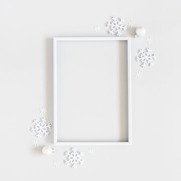 Christmas composition. Photo frame, snowflakes on pastel gray background. Christmas, winter, new year concept. Flat lay, top view, copy space, sguare