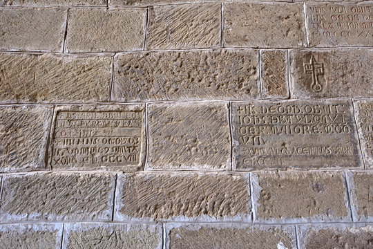 inscriptions of thetombstones between the mozarabe door and gothic chapel of San Victorian, Old Monastery of San Juan de la Pena, Huesca province, Aragon, Spain