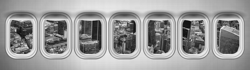 Airplane interior with window view of London City, United Kingdom. Concept of travel and air transportation