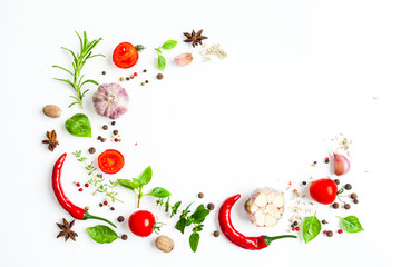 Spices and herbs as a border isolated on white