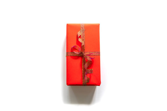 Creative Christmas Composition Of Gift Box With Gold Tape On White Background. Top View With Copy Space.