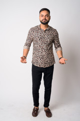 Full body shot of young bearded Indian man