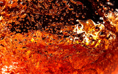 Alcoholic drink on a dark background, abstract splashing.