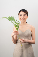 Beautiful woman of Asian appearance palm leaf nature skin care
