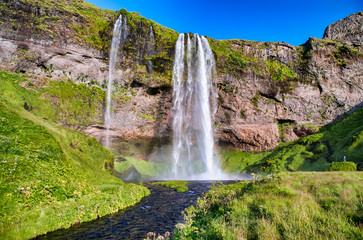 Beautiful view of Seljalandfoss Waterfalls in Iceland on a sunny summer day