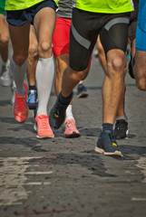 CHERNIVTSI, UKRAINE - SEPTEMBER 29. 2019 :athletes participating in Championship of Ukraine. Sneakers, legs and granite pavement closeup. Sneakers are blurred in motion.