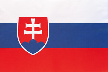 Slovakia national fabric flag, textile background. Symbol of international world european country.