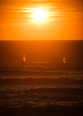 windsurfers at sunset