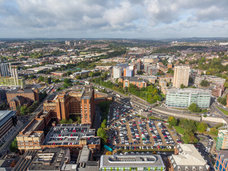 Aerial photo taken on the centre of Leeds in the UK, showing the typical British town centre along with hotels, businesses and shopping centres, taken on a bright sunny part cloudy day