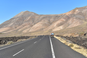 Group of cyclists pedaling on open road, Lanzarote, Canary Islands, Spain