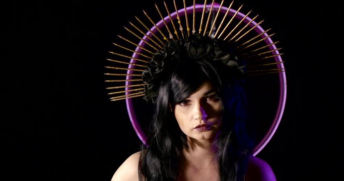 woman looks like gothic punk Holy virgin, stands near violet neon light, image for Halloween