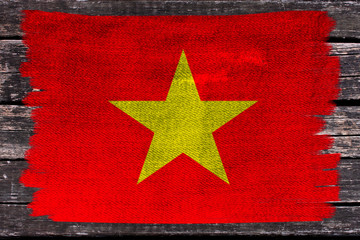 beautiful photo of the colored national flag of the modern state of Vietnam on a textured fabric,...
