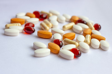 Many different pharmaceutical medicine pills, tablets and capsules on white background. Pharmacy theme, health care, drug prescription for treatment medication and medicament