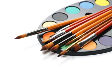 Color palette with brushes, painting utensils isolated on white background