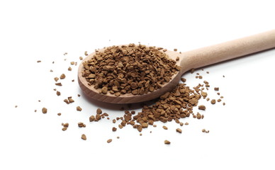 Instant coffee granules with wooden spoon, isolated on white background