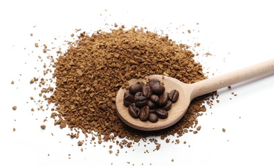 Instant coffee granules and beans with wooden spoon, isolated on white background