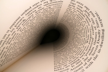 Inside the book concept. Latin letters and words on an tunnel shaped, perspective book page with black dramatic light. Education, knowledge concept