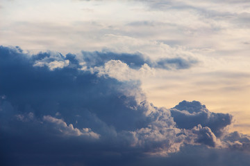 Blue curly clouds in the evening sky_