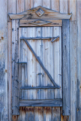 Spare wooden door in an old wooden house.