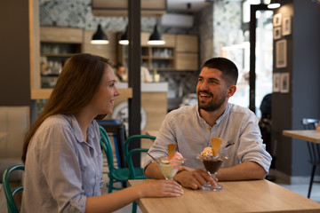 happy couple eating ice cream indoor