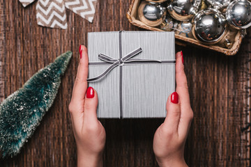 Christmas Background with women's hand wrapping Christmas Gift