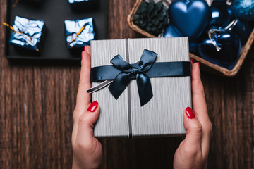 Christmas Background with women's hand wrapping Christmas Gift