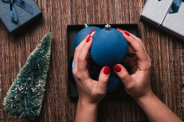 Christmas Background with women's hand holding Christmas decorative ball