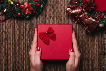 Christmas Background with women's hand wrapping Christmas Gift