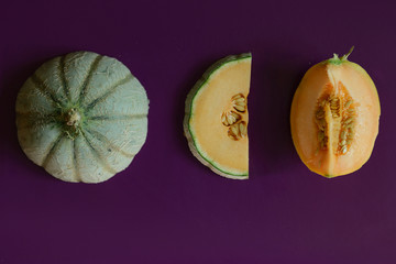 Melon in the cut orange melon on a purple background