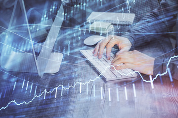 Double exposure of financial graph with man works in office on background. Concept of analysis.