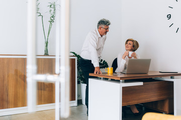 businesspeople working together in office on laptop computer