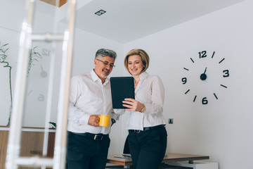 businesspeople working together in office on tablet computer