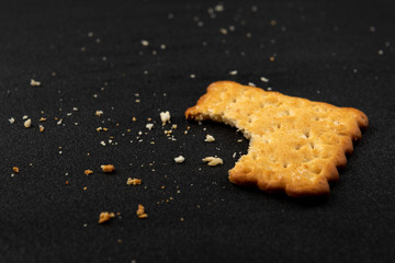 Cracker with sesame on black background.