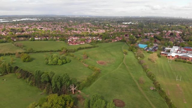 Aerial Panning Shot Of Birmingham Viewed Across Modern Secondary School And Solihull Suburban Landscape Spring Cloudy Blue Sky 4K