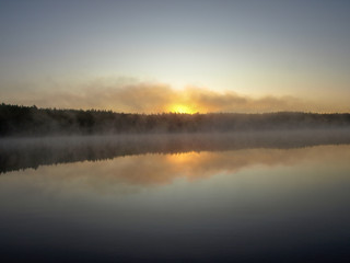 Fototapeta na wymiar beautiful mist on the lake, outline, sunrise, autumn morning
