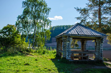 wooden gazebo on the river Bank