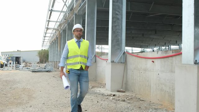 portrait of handsome foreman construction worker on a industrial building industry construction site 4 K 50 fps footage