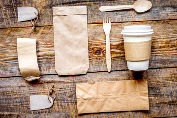 Fototapeta na wymiar breakfast take away with paper bags on wooden table background top view mock up
