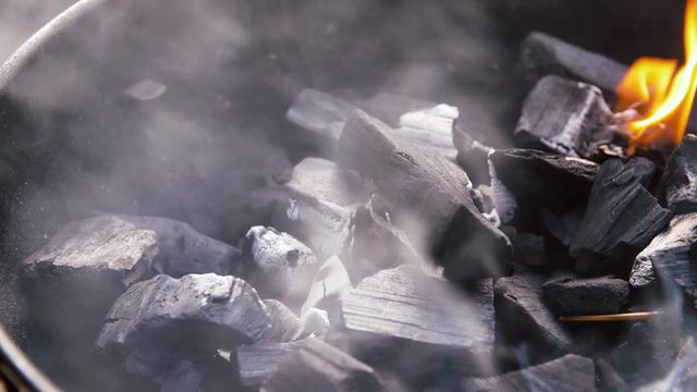 cooking, heat and fire concept - charcoal burning in brazier outdoors