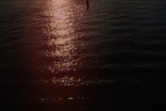 red reflection of sun in water © Виктория Бойко